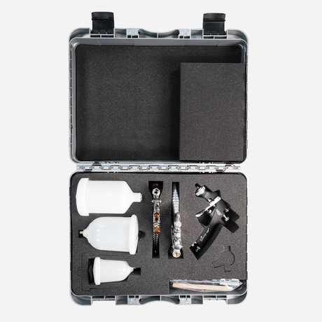 Set of spray paint tools in a black case on a white background